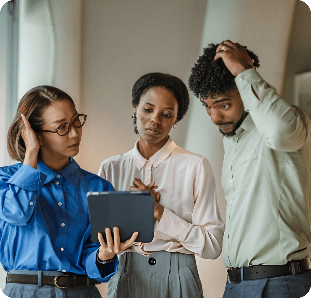 Three agency teammates crowded around one tablet, looking overwhelmed