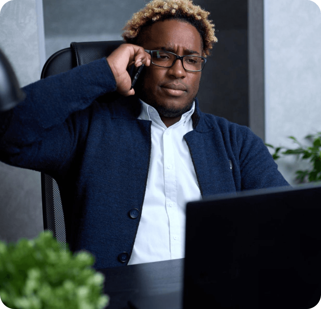 A business owner on the phone at his desk, chasing a lead that went quiet