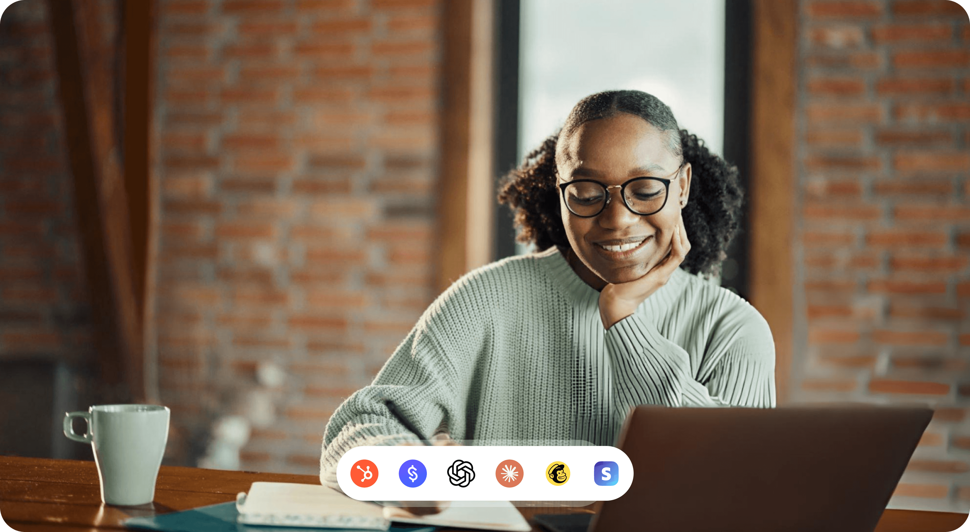 A creator smiling at a laptop while their connected tools work together