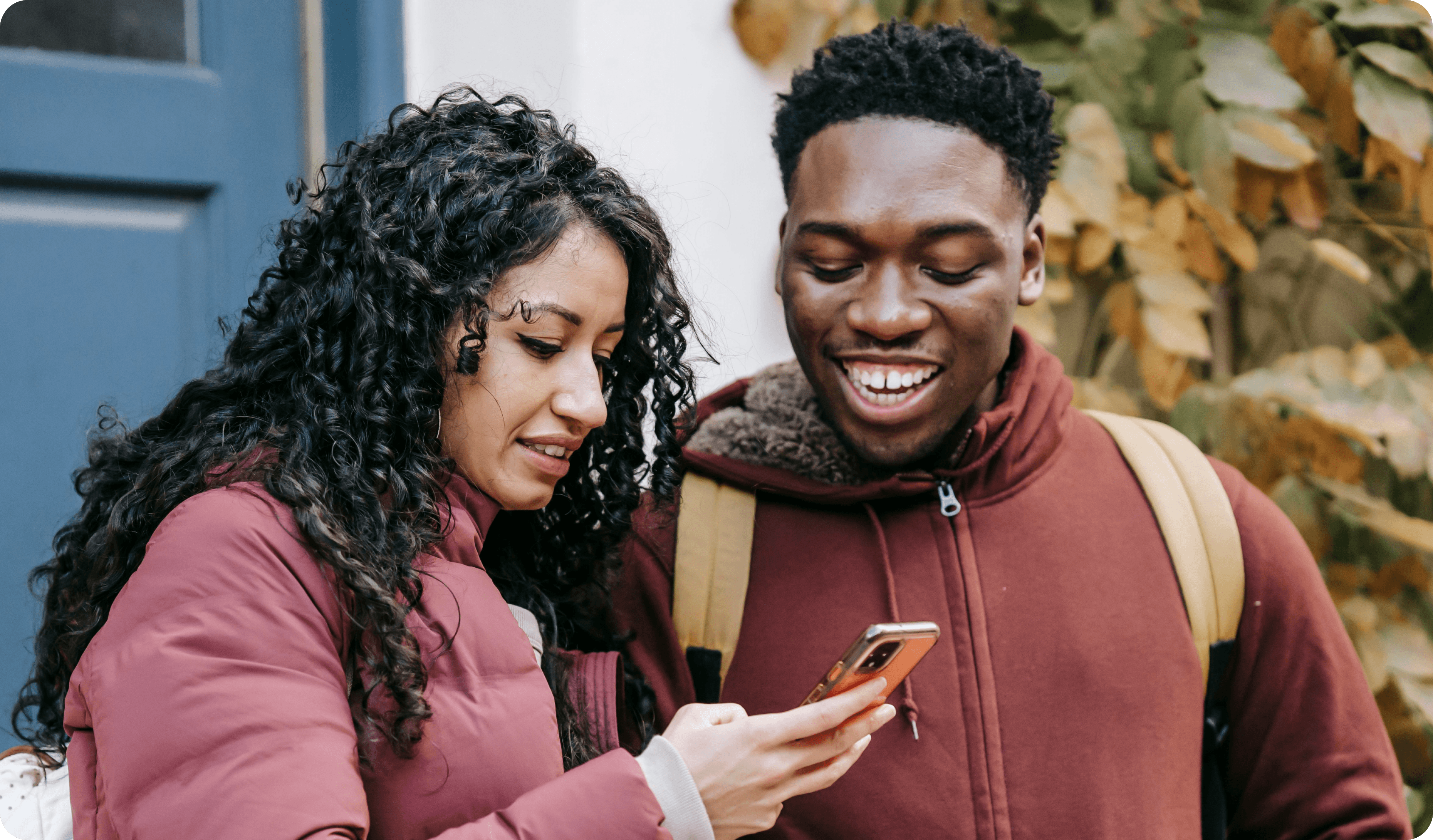 Two people looking at a phone together