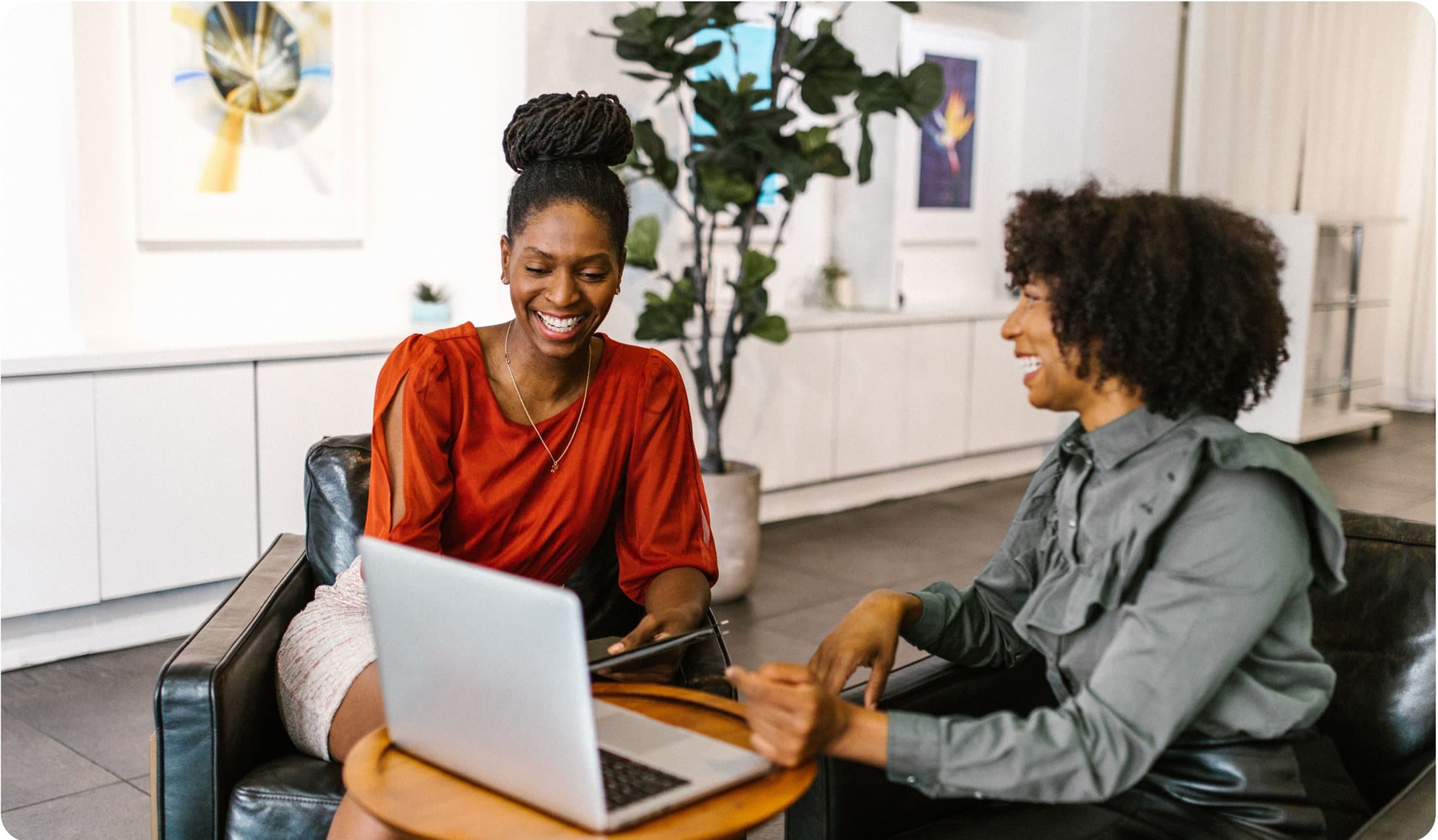 Two creators reviewing their SMS campaigns together on a laptop
